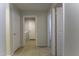 Hallway with tan tile flooring and multiple doors leading to other rooms at 1391 E 12Th St, Casa Grande, AZ 85122