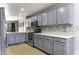 Updated kitchen featuring stainless steel appliances, gray cabinets, and tile flooring at 1391 E 12Th St, Casa Grande, AZ 85122