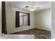 Living area featuring wood-style flooring, neutral walls, window with privacy blinds, and a ceiling fan at 1391 E 12Th St, Casa Grande, AZ 85122