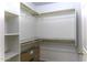 Walk-in closet with built-in shelving and wood rods for hanging clothes at 1391 E 12Th St, Casa Grande, AZ 85122