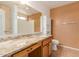 Bright bathroom featuring a granite countertop, updated vanity, and a large mirror at 1422 S 231St Ln, Buckeye, AZ 85326