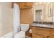 Well-lit bathroom with a shower, granite vanity and tiled floors at 1422 S 231St Ln, Buckeye, AZ 85326