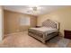 Bedroom with tile flooring, ceiling fan, and a statement upholstered king-size bed at 1422 S 231St Ln, Buckeye, AZ 85326