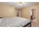 Bedroom with tile flooring, ceiling fan, upholstered king-size bed, and ensuite bathroom at 1422 S 231St Ln, Buckeye, AZ 85326