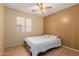 Inviting bedroom with neutral tones, tiled floor, and window with blinds at 1422 S 231St Ln, Buckeye, AZ 85326