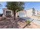 Charming single-story home featuring a well-maintained front yard, two-car garage, and a terracotta-tiled roof at 1422 S 231St Ln, Buckeye, AZ 85326