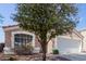 Charming single-story home featuring a well-maintained front yard, two-car garage, and a terracotta-tiled roof at 1422 S 231St Ln, Buckeye, AZ 85326