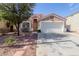 Charming single-story home featuring a well-maintained front yard, two-car garage, and a terracotta-tiled roof at 1422 S 231St Ln, Buckeye, AZ 85326