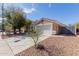 Charming single-story home featuring a well-maintained front yard, two-car garage, and a terracotta-tiled roof at 1422 S 231St Ln, Buckeye, AZ 85326