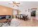 Inviting living room with a large dining table, plush gray sofas, and stylish decor, perfect for relaxing and entertaining at 1422 S 231St Ln, Buckeye, AZ 85326