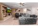 Comfortable living room with a ceiling fan, tile flooring, and a cozy gray oversized sectional at 1422 S 231St Ln, Buckeye, AZ 85326