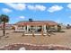 Expansive backyard with patio, ideal for outdoor living and entertaining, set against a clear blue sky at 14710 W Yosemite Dr, Sun City West, AZ 85375