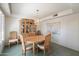 Formal dining room with a wooden table and chairs, elegant chandelier, and display cabinet at 14710 W Yosemite Dr, Sun City West, AZ 85375