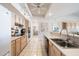 Bright kitchen featuring a double basin sink, white appliances, and plenty of natural light at 14710 W Yosemite Dr, Sun City West, AZ 85375