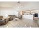 Open-concept living room with tile flooring seamlessly connecting to the kitchen and dining area at 14710 W Yosemite Dr, Sun City West, AZ 85375