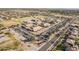 Aerial shot of the school with a track field, baseball field and rows of parked vehicles, surrounded by a desert landscape at 1473 E Mead Dr, Chandler, AZ 85249