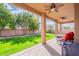 Covered patio with ceiling fans overlooks a well-maintained, grassy backyard at 1473 E Mead Dr, Chandler, AZ 85249