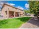 Spacious backyard features a covered patio, lush lawn, mature trees and is perfect for outdoor entertaining at 1473 E Mead Dr, Chandler, AZ 85249