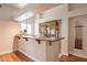 This home's bar area features a sink, wood cabinets, and access to an adjacent dining and entertaining area at 1473 E Mead Dr, Chandler, AZ 85249