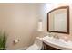 Cozy half bath featuring a pedestal sink and decorative mirror at 1473 E Mead Dr, Chandler, AZ 85249