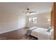 This bedroom features hardwood floors, a comfortable bed, and a ceiling fan at 1473 E Mead Dr, Chandler, AZ 85249