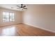 A simple bedroom shows hardwood floors, a modern ceiling fan and a view through a window at 1473 E Mead Dr, Chandler, AZ 85249