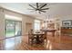 Bright dining area featuring hardwood floors, fan, bar, and access to the yard through a glass sliding door at 1473 E Mead Dr, Chandler, AZ 85249