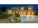 Beautiful two-story home with a three-car garage and lush, green landscaping at 1473 E Mead Dr, Chandler, AZ 85249