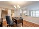 Bright home office featuring a wooden desk and hardwood floors at 1473 E Mead Dr, Chandler, AZ 85249