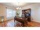 Stately home office featuring a large wooden desk and hutch with hardwood floors and natural light at 1473 E Mead Dr, Chandler, AZ 85249