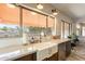 Bright kitchen with farmhouse sink, marble countertops, and window with outdoor views at 1473 E Mead Dr, Chandler, AZ 85249