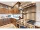 Well-equipped kitchen with stainless steel appliances and custom wood cabinetry at 1473 E Mead Dr, Chandler, AZ 85249