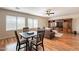 This home's living room features hardwood floors, a comfortable sofa, and an adjacent dining area at 1473 E Mead Dr, Chandler, AZ 85249