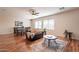 This home's living room features hardwood floors, a comfortable sofa, and an adjacent dining and entertaining area at 1473 E Mead Dr, Chandler, AZ 85249