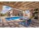 Inviting backyard pool area with patio, umbrellas, and seating, perfect for outdoor relaxation and entertaining at 1473 E Mead Dr, Chandler, AZ 85249