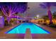 Stunning backyard pool with a diving board, lit pool lights, and desert landscaping at 1473 E Mead Dr, Chandler, AZ 85249