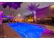 Sparkling backyard pool with diving board, lounge chairs, and illuminated landscaping at 1473 E Mead Dr, Chandler, AZ 85249