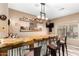 This home bar features a live edge countertop, corrugated metal accents, and floating shelves stocked with spirits at 15620 W Meadowbrook W Ave, Goodyear, AZ 85395