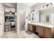 Bathroom with double sink vanity, shower, and soaking tub next to the main bedroom at 15620 W Meadowbrook W Ave, Goodyear, AZ 85395