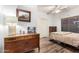 Cozy bedroom with wood-look flooring, closet, and reading chair at 15620 W Meadowbrook W Ave, Goodyear, AZ 85395