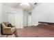 Bedroom with wood-look floors, an armchair, and a closet with sliding doors at 15620 W Meadowbrook W Ave, Goodyear, AZ 85395