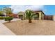 Charming home featuring a three-car garage, desert landscaping, and a welcoming entrance at 15620 W Meadowbrook W Ave, Goodyear, AZ 85395