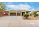 Charming home featuring a three-car garage, desert landscaping, and a welcoming entrance at 15620 W Meadowbrook W Ave, Goodyear, AZ 85395