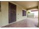 Inviting front porch with tiled floor, decorative door, and ample space for seating at 15620 W Meadowbrook W Ave, Goodyear, AZ 85395