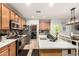 Bright kitchen with stainless steel appliances, a central island with sink, and ample cabinet space for storage at 15620 W Meadowbrook W Ave, Goodyear, AZ 85395