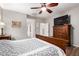 A traditional main bedroom features a ceiling fan, wooden furniture, and gray walls at 15620 W Meadowbrook W Ave, Goodyear, AZ 85395