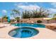 Inviting backyard pool and spa with rock features and desert landscaping for a relaxing outdoor oasis at 15620 W Meadowbrook W Ave, Goodyear, AZ 85395