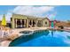 Inviting pool area with lounge chairs and a covered patio, perfect for outdoor relaxation and entertaining at 15620 W Meadowbrook W Ave, Goodyear, AZ 85395