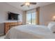 Bright bedroom with a large window and a traditional wooden dresser with a TV at 16203 E Ridgeline Dr, Fountain Hills, AZ 85268