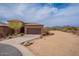 Attractive home featuring a brown garage door, desert landscaping, and paved driveway at 16203 E Ridgeline Dr, Fountain Hills, AZ 85268